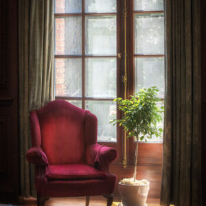 Window with a red chair.