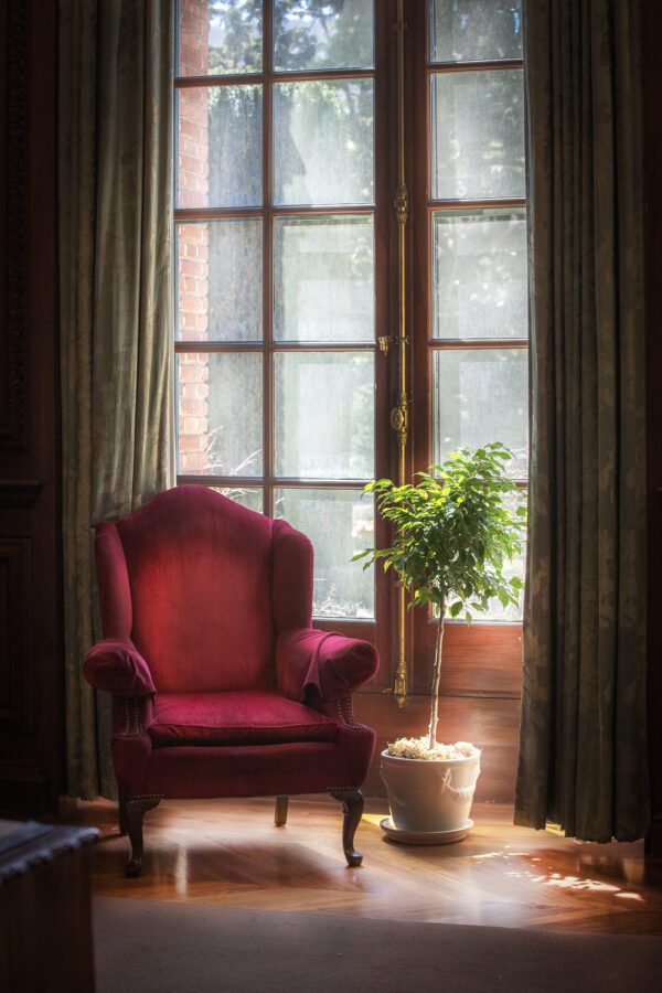 Window with a red chair.